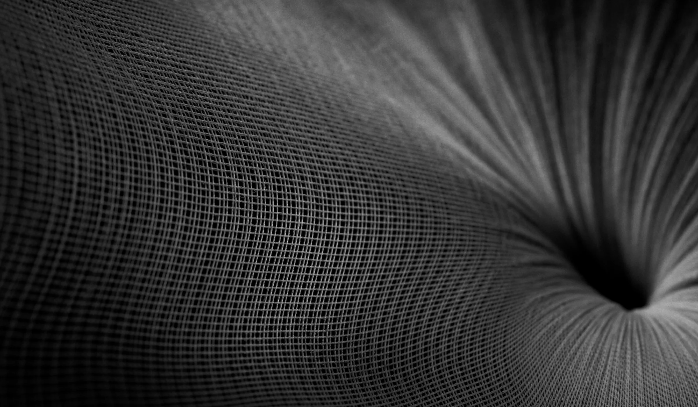 Woven mesh pulled toward a single point — the pull of what's next